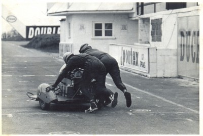 Dave Wallace (pass) Malcolm Caley (dvr) on Dave Ajax' Norton, Snetterton 1964.jpg